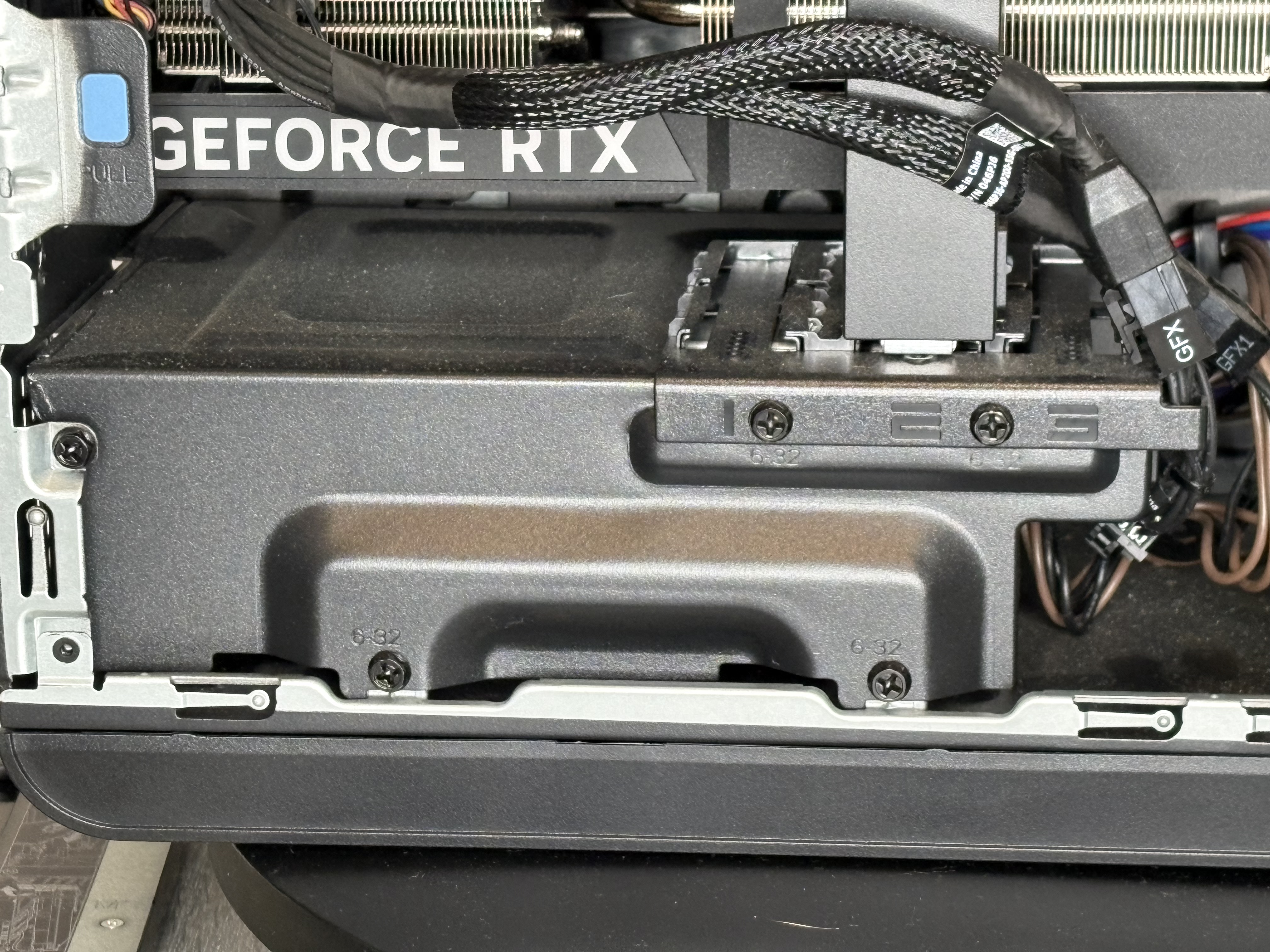 Close-up of the graphics card and power supply area inside the store-bought gaming desktop